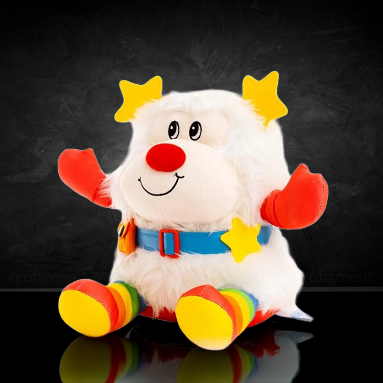 The Loyal Subjects Rainbow Brite Twink 10-inch plush doll with white fur and colorful star accessories seated on black background