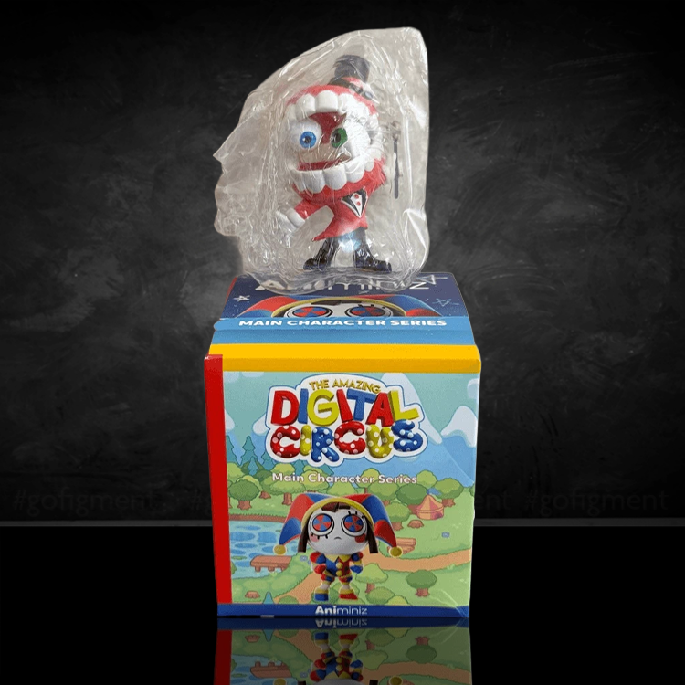 Collectible figure wrapped in clear plastic standing atop a colorful "The Amazing Digital Circus" box with character artwork.