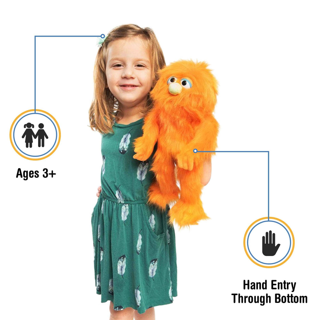 Silly Puppets - Silly Puppets Monster, Orange (14") plush with bright orange fur and green nose held by smiling young girl in green dress