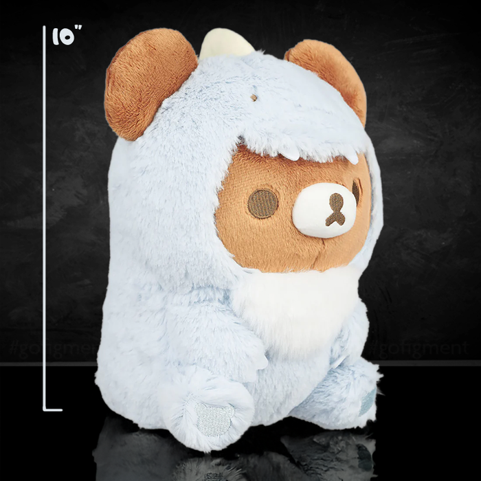San-X Chairoikoguma plush in light blue dinosaur costume sitting upright on black surface with size marker