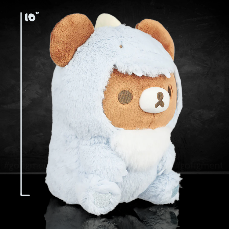 San-X Chairoikoguma plush in light blue dinosaur costume sitting upright on black surface with size marker