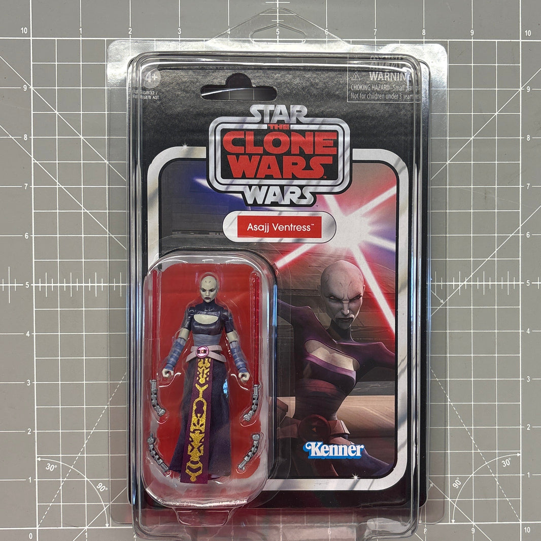 Packaged Star Wars The Clone Wars Asajj Ventress action figure on a gridded cutting mat