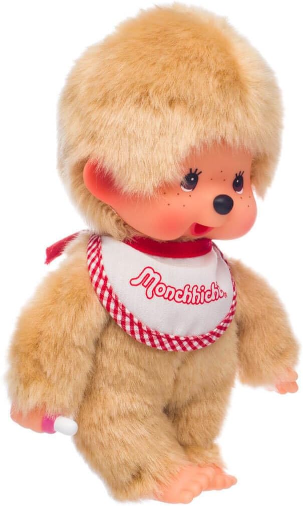Sekiguchi Monchhichi 8-inch beige boy plush with soft fur, red and white bib, and thumb-sucking pose.