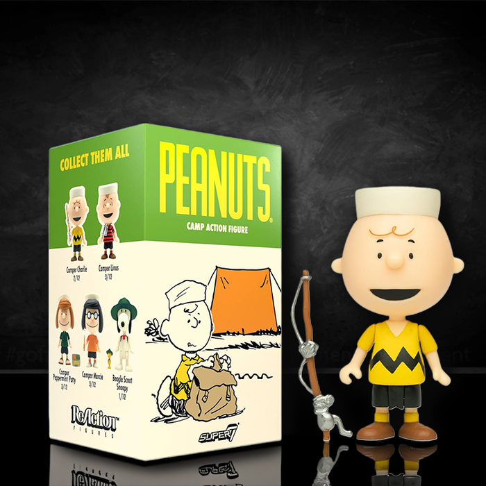 Loose Super7 Peanuts Camper Charlie Brown action figure with fishing pole and green collectible box with character illustrations