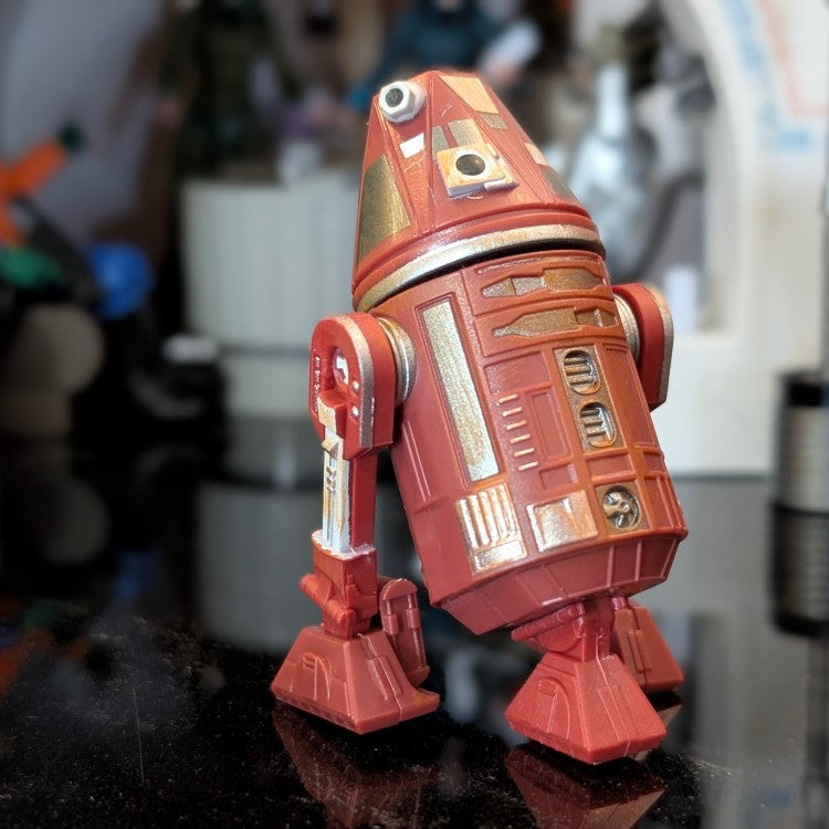 Loose C4-R4C Star Wars Droid Factory action figure in red and gold, ready for display by Disney Droid Factory