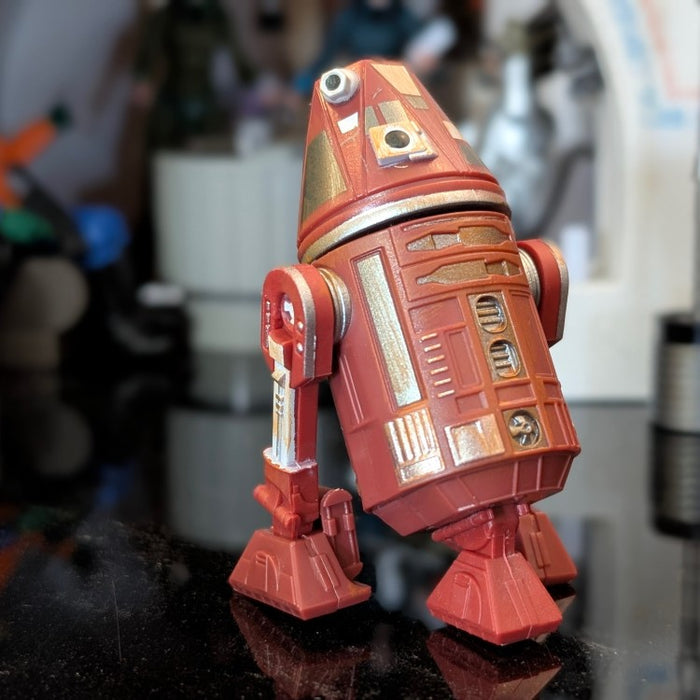 Loose C4-R4C Star Wars Droid Factory action figure in red and gold, ready for display by Disney Droid Factory