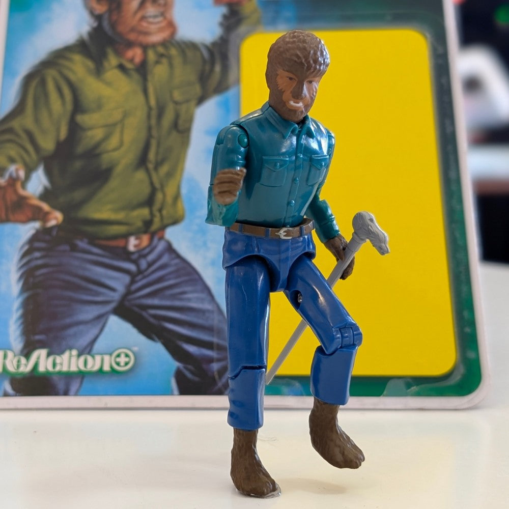 Universal Monsters Wolf Man 3 3/4-inch ReAction+ figure by Hasbro in blue shirt with tool accessory in front of box
