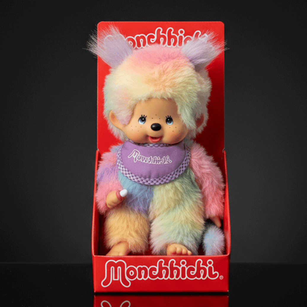 Sekiguchi 8-inch Monchhichi girl doll in pastel tie-dye plush seated in red branded display box