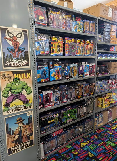 Metal shelving unit displaying Marvel Legends and X-Men action figures with vintage comic posters on side and colorful carpet below