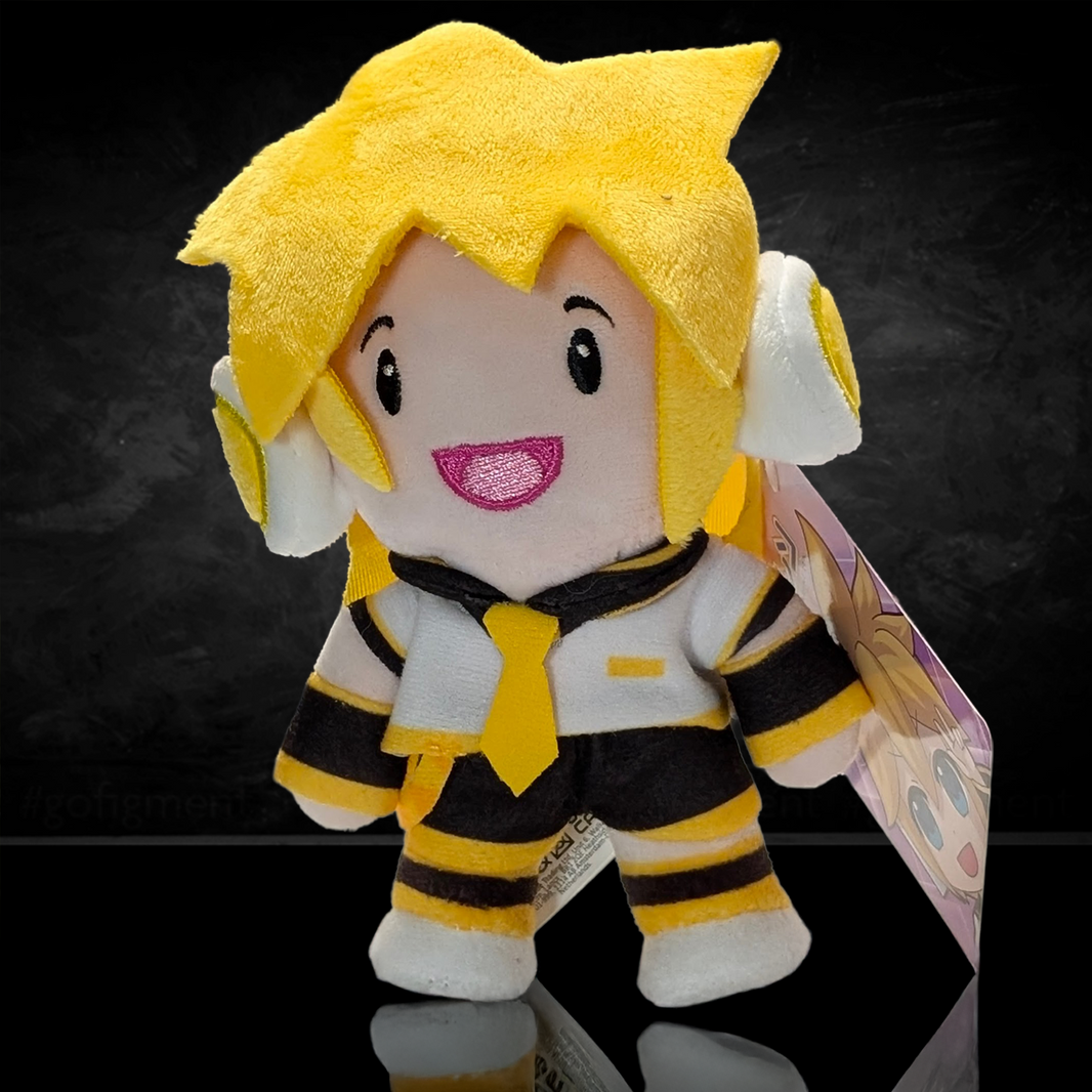 UCC 6-inch Kagamine Len plush with bright yellow hair, white headphones, black and yellow outfit, smiling against dark background