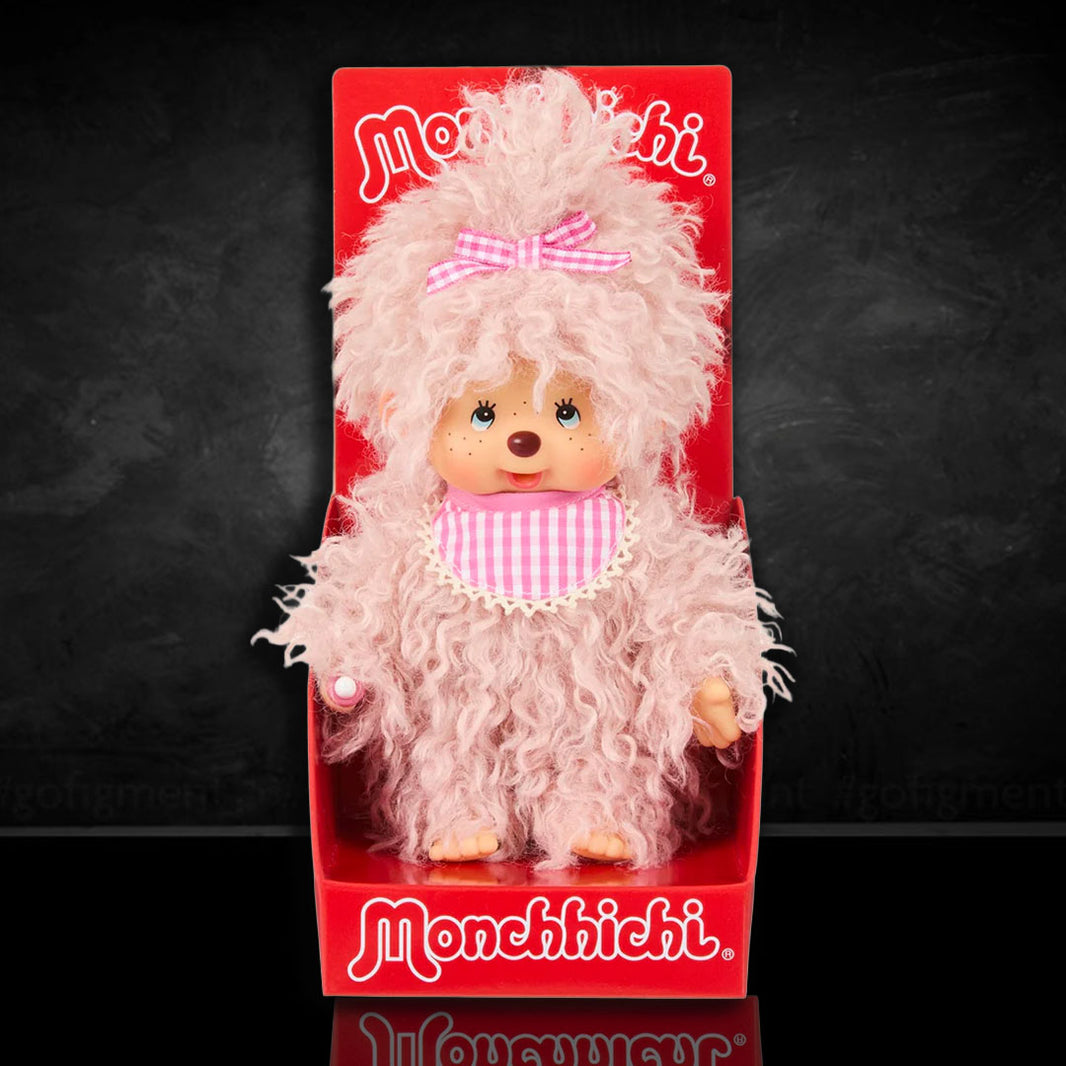 Sekiguchi Monchhichi plush doll with fluffy pink beige fur, gingham bib and bow, in classic thumb-sucking pose