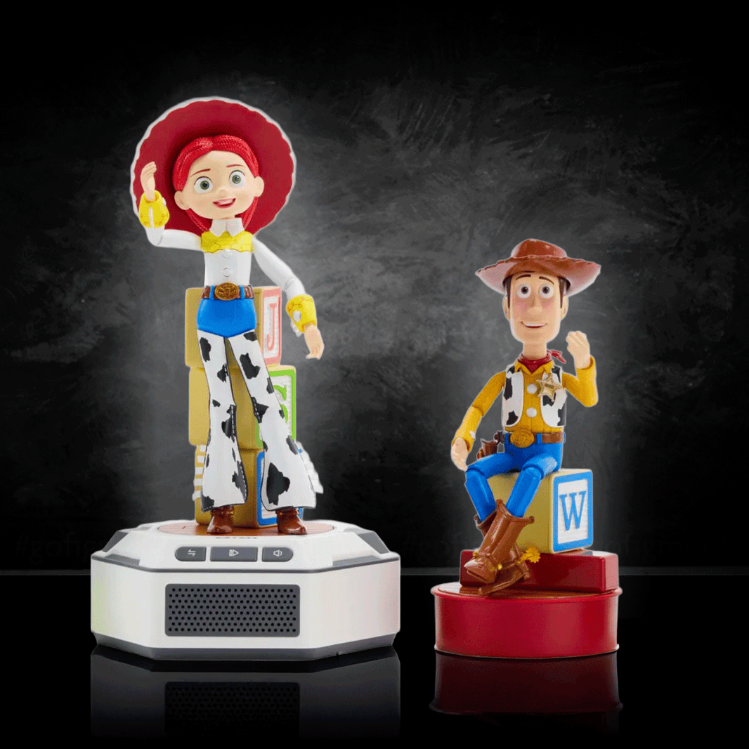 Woody and Jessie mini robot figures with bases by Robesen Robotics, posed against dark background on reflective surface