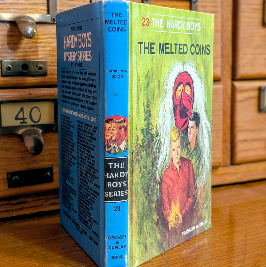 Vintage Hardy Boys book The Melted Coins 23 from 1970 by Grosset & Dunlap with blue spine and illustrated cover