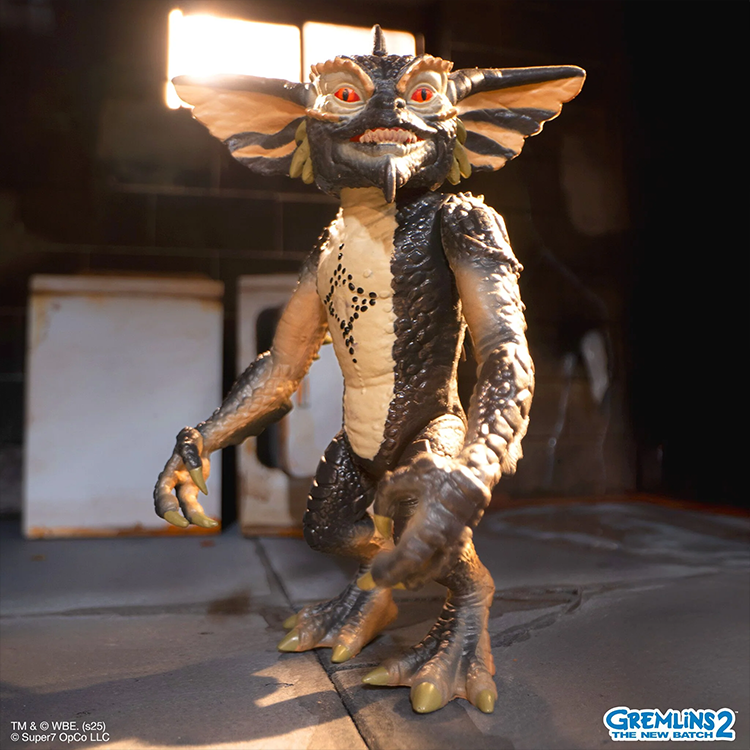 Super7 Gremlins 2 Mohawk figure with detailed scales and red eyes standing in dimly lit room