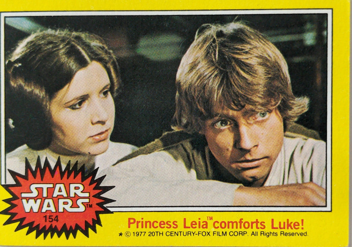 1977 Topps Star Wars trading card featuring Princess Leia comforting Luke Skywalker in yellow series 3 design