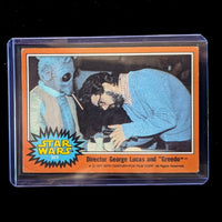 1977 TOPPS STAR WARS Orange Series 4 trading card of George Lucas directing Greedo in protective plastic case by Go Figment