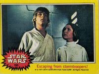 1977 Topps Star Wars Series 3 yellow card featuring Luke Skywalker and Princess Leia from original film scene