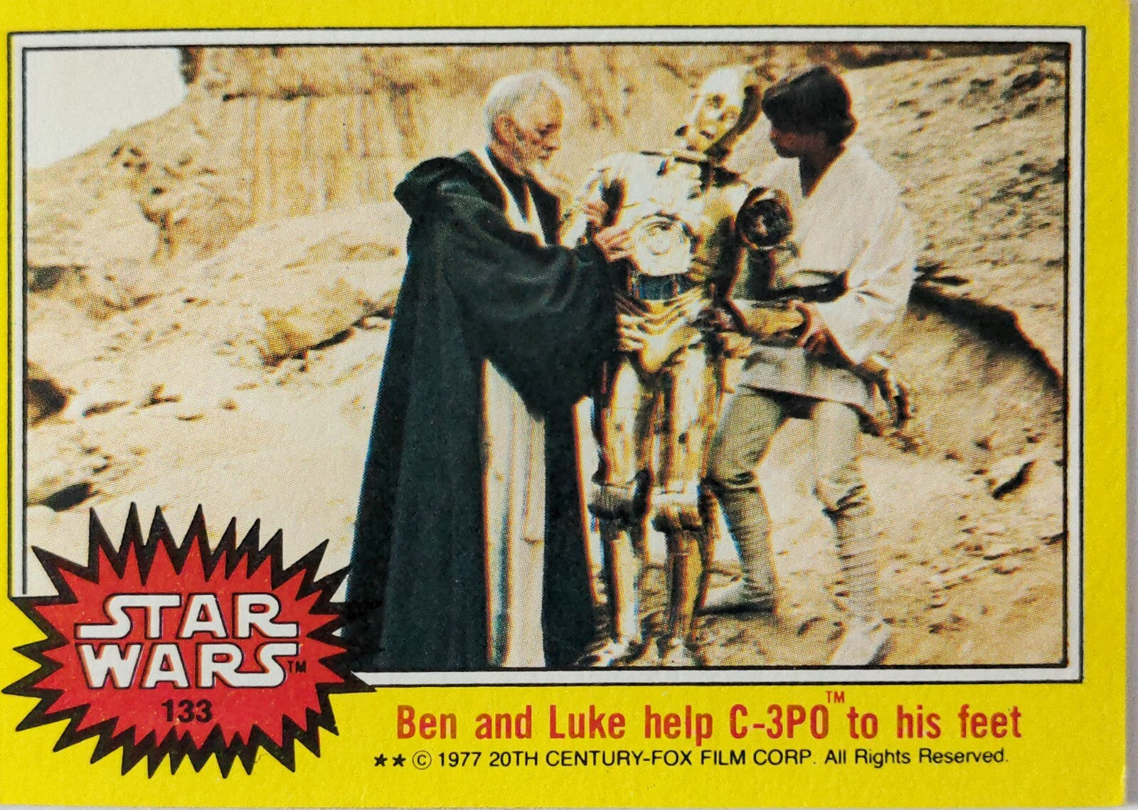 1977 Topps Star Wars trading card showing Ben Kenobi and Luke Skywalker helping C-3PO stand in desert scene
