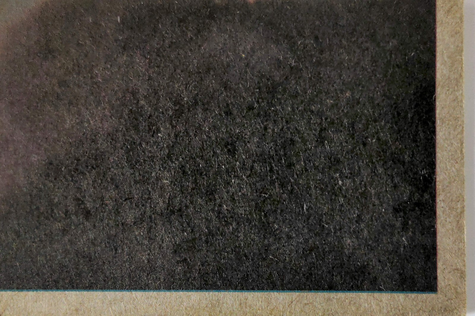 Close-up of vintage 1977 Topps Star Wars trading card corner showing textured back and aged edges