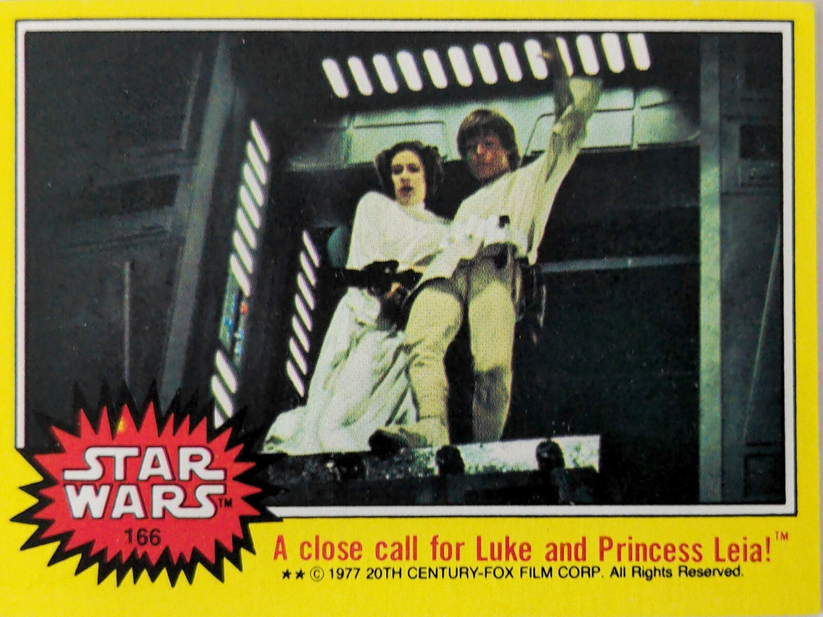 Topps 1977 Star Wars trading card featuring Luke Skywalker and Princess Leia in action scene from film