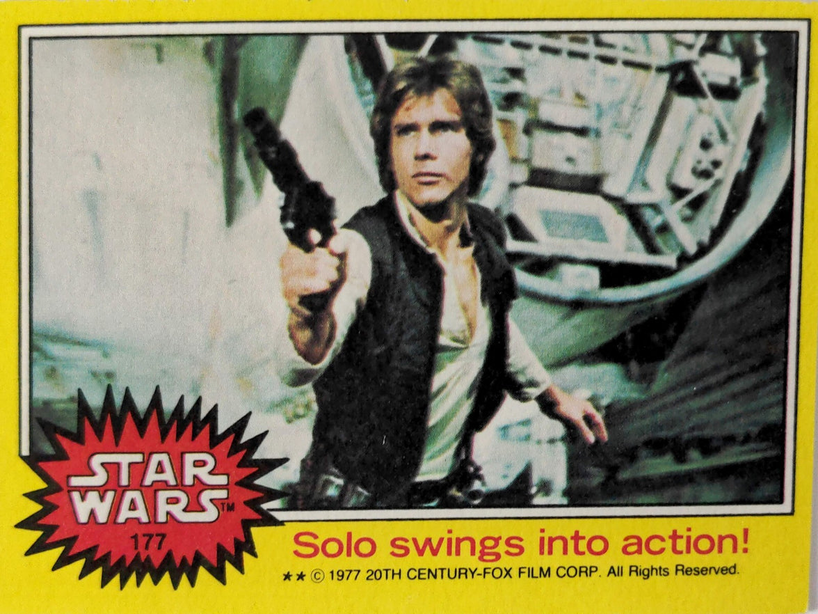 1977 Topps Star Wars yellow Series 3 trading card featuring Han Solo aiming blaster in spaceship interior