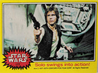 1977 Topps Star Wars yellow Series 3 trading card featuring Han Solo aiming blaster in spaceship interior