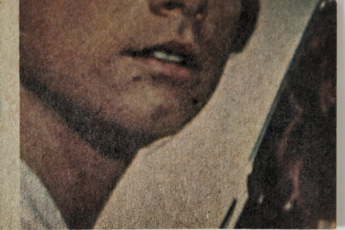Close-up of 1977 Topps Star Wars Trading Card featuring Luke Skywalker with lightsaber from Yellow Series 3 set