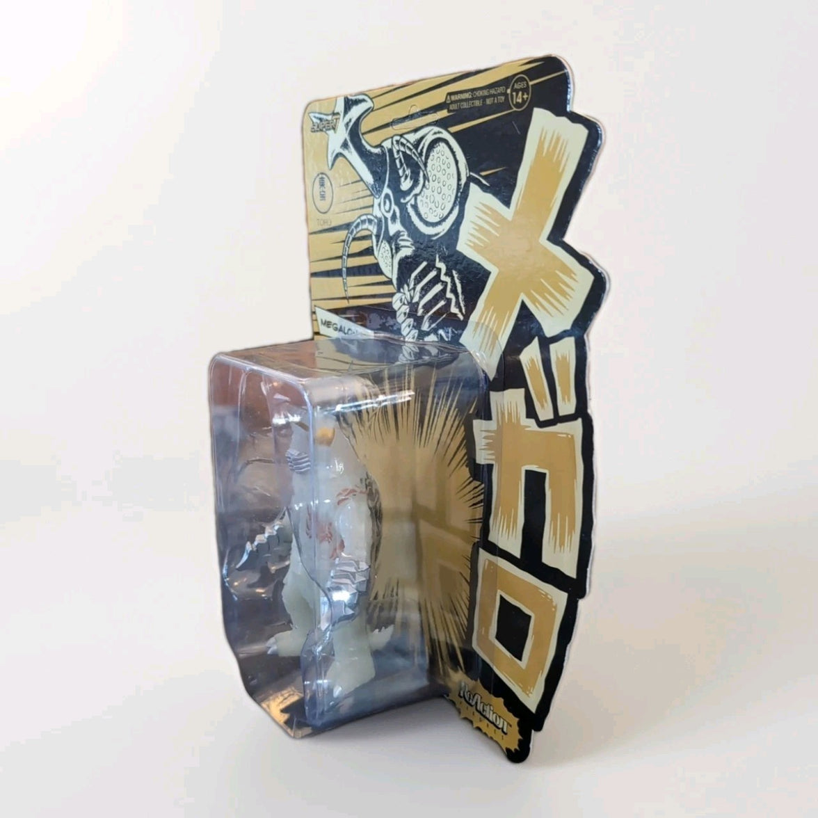 Super7 Megalon 1973 glow-in-the-dark figure in original out-of-print first run packaging with bold Japanese design