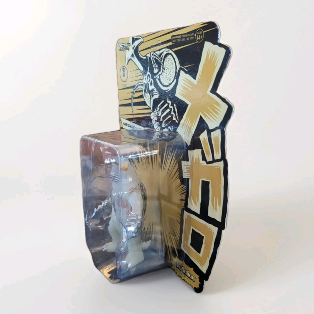 Super7 Megalon 1973 glow-in-the-dark figure in original out-of-print first run packaging with bold Japanese design