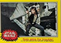 1977 Topps Star Wars card featuring Han Solo aiming blaster in yellow Series 3 trading card design