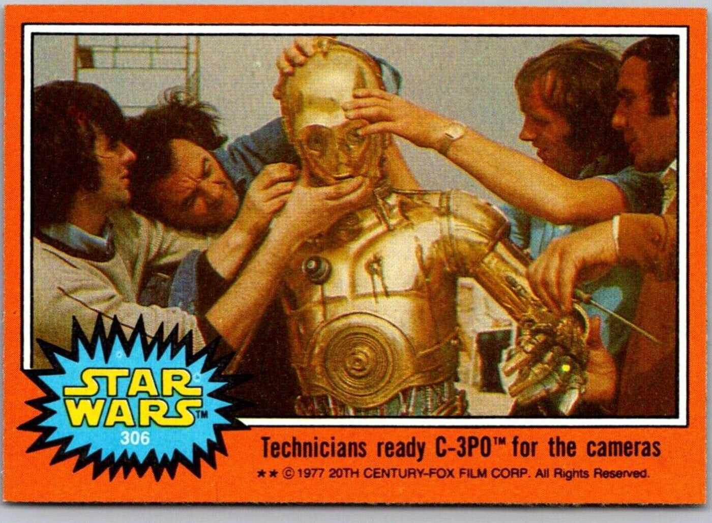1977 Topps Star Wars Orange Series 4 card showing technicians adjusting C-3PO droid on movie set by Go Figment