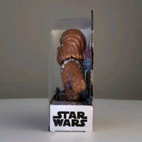 Side view of Hasbro Star Wars Chewbacca Bop It electronic game in original packaging against gray background