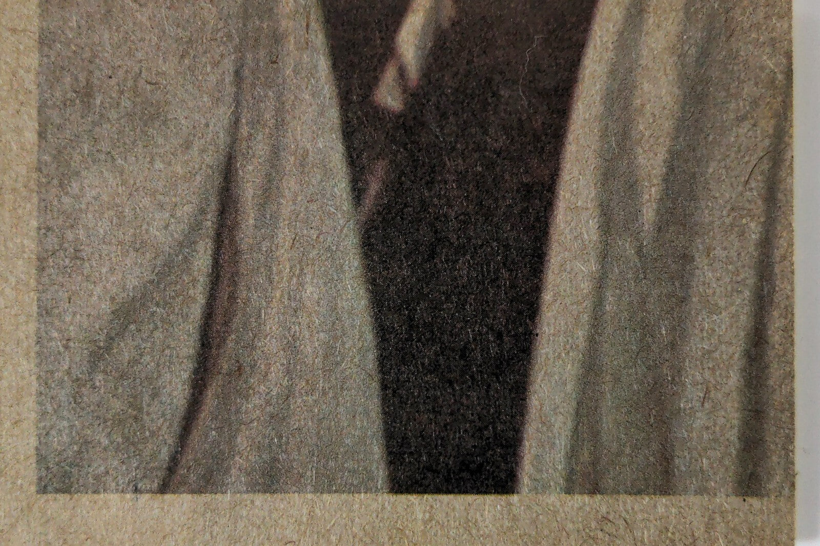 Close-up of vintage 1977 Topps Star Wars trading card edge showing textured paper and partial figure sleeve