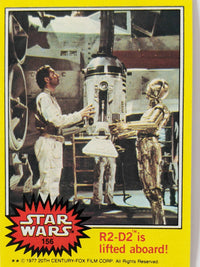 1977 Topps Star Wars trading card featuring R2-D2 being lifted aboard with C-3PO and technician in background