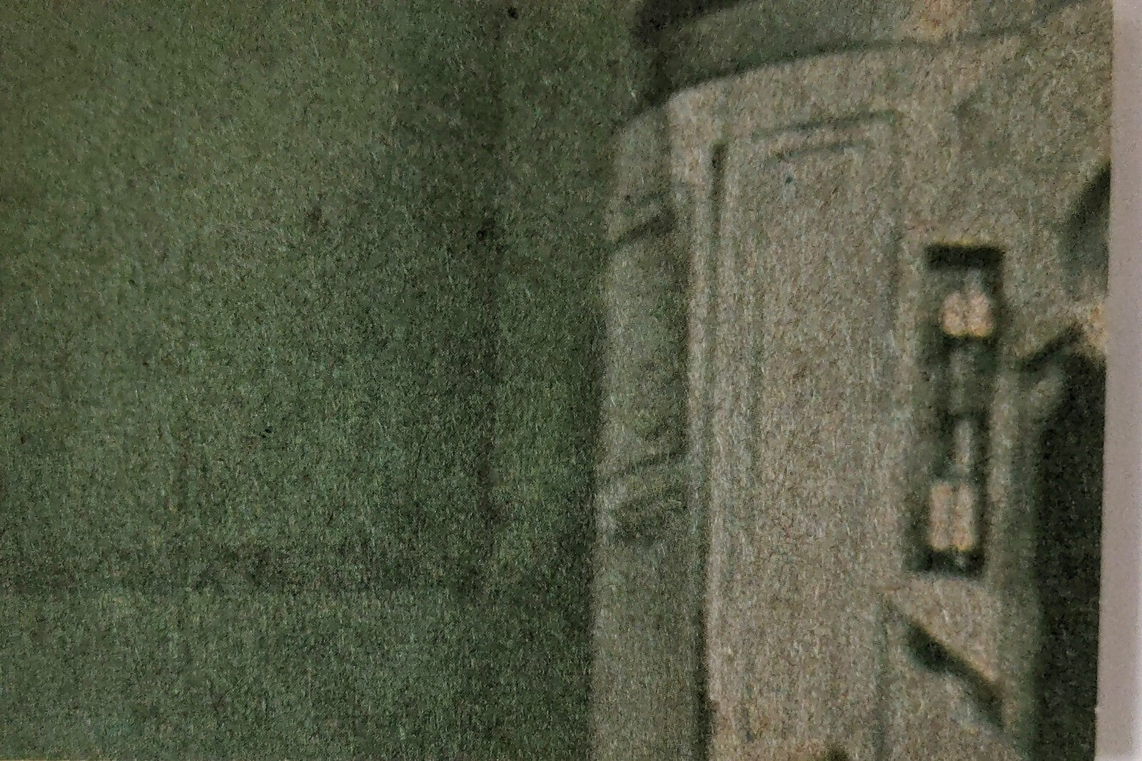 Close-up of vintage 1977 Topps Star Wars yellow Series 3 trading card corner with textured background