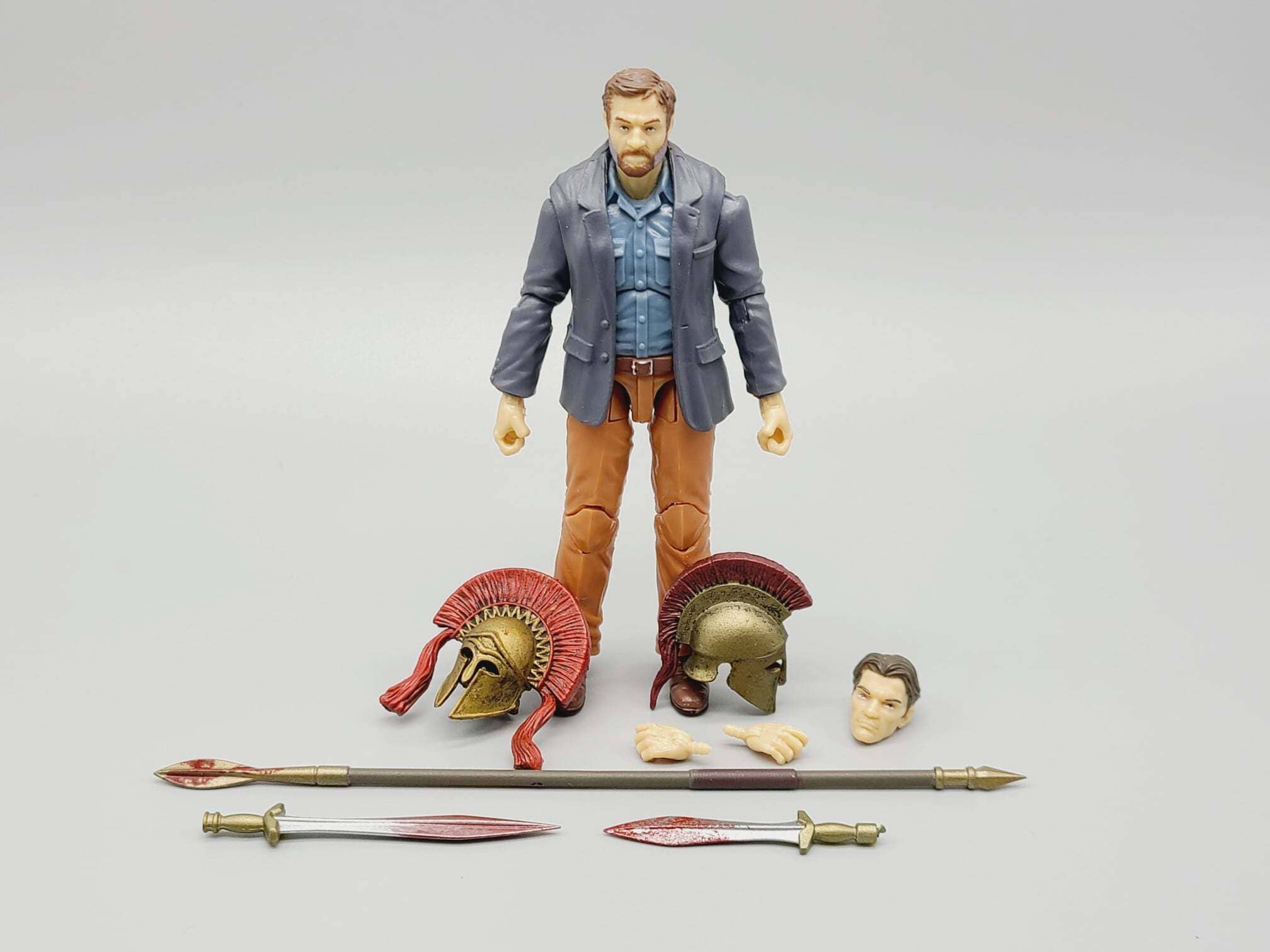 Action figure with accessories on a gray background