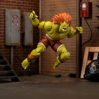 Jada Toys Ultra Street Fighter II Blanka deluxe 6-inch action figure posed in industrial urban setting