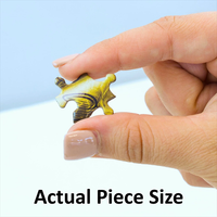 Close-up of hand holding a single yellow alien-shaped puzzle piece from Master Pieces 300-piece jigsaw puzzle