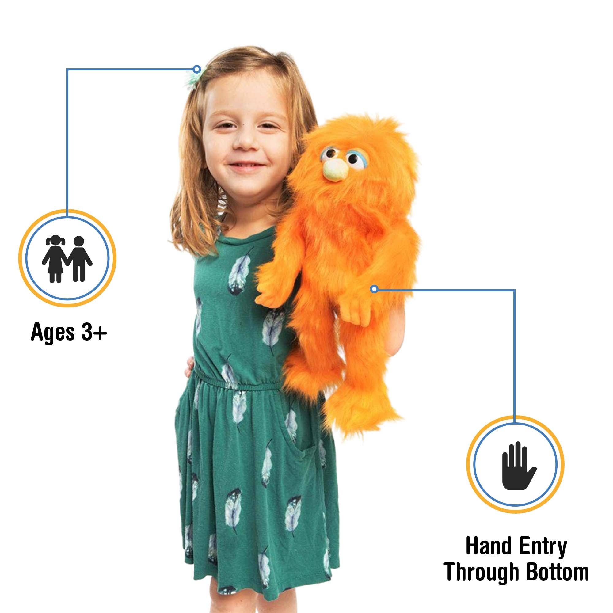 Silly Puppets - Silly Puppets Monster, Orange (14") plush with bright orange fur and green nose held by smiling young girl in green dress
