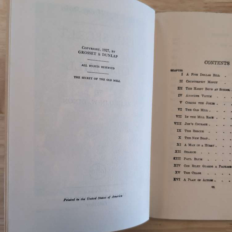 Open pages of 03 The Secret of the Old Mill Hardy Boys book showing copyright by Grosset & Dunlap and chapter contents list