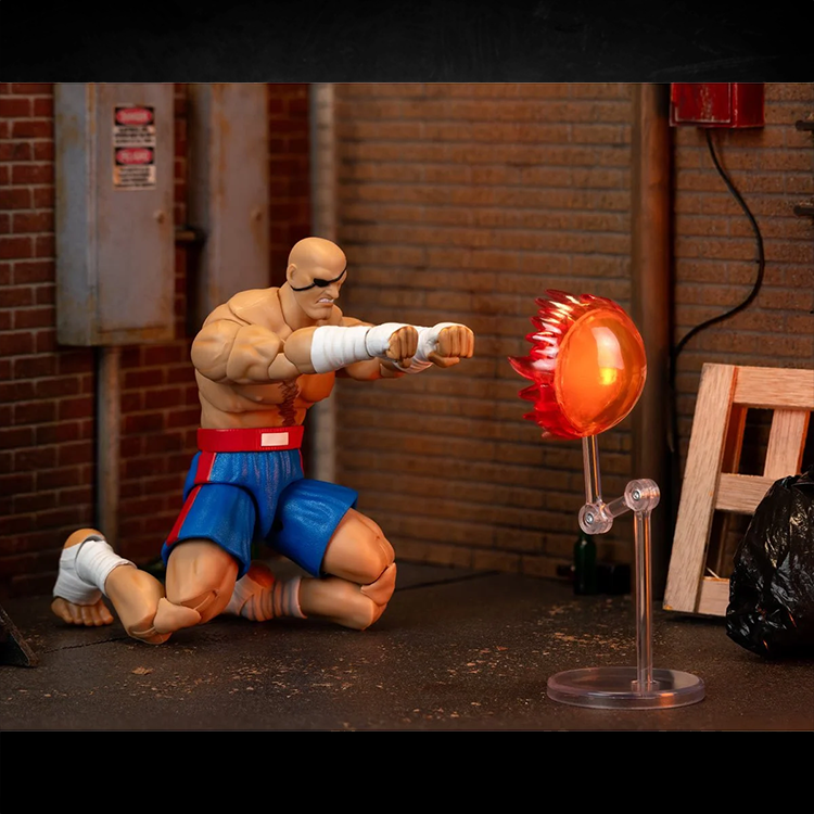 Jada Toys Ultra Street Fighter II Sagat 6-inch action figure in fighting pose with fire effect accessory on urban diorama