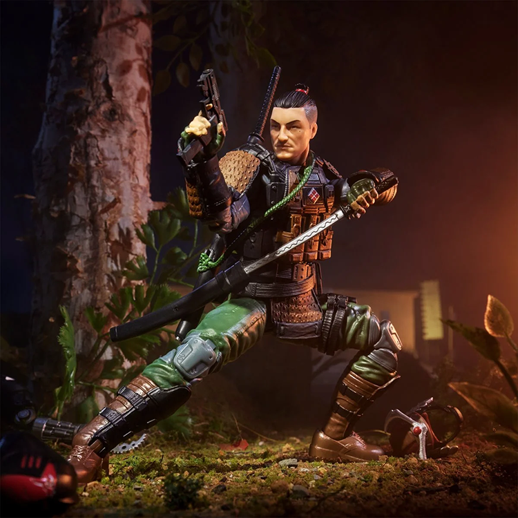 Hasbro Kyle Budo action figure in samurai armor posed with sword and pistol on forest floor background