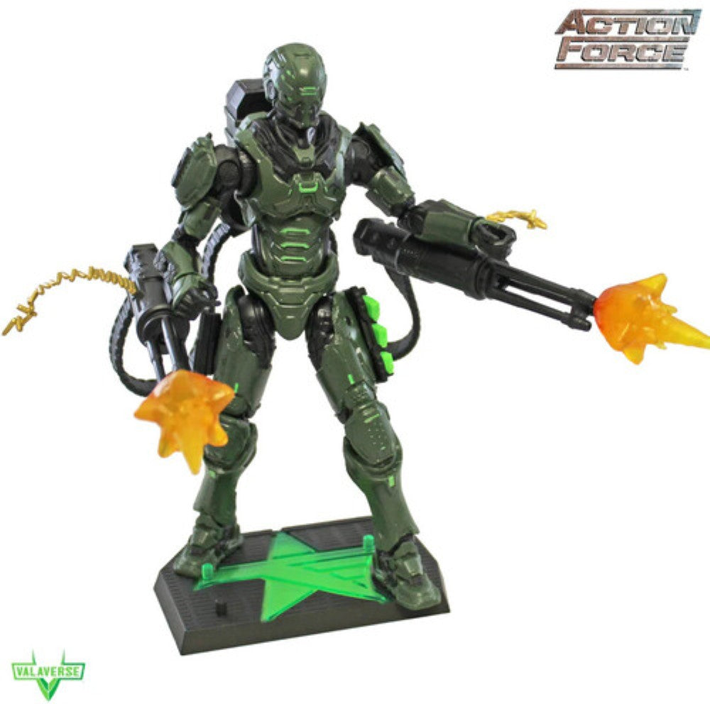 Green armored Action Force figure holding a large blaster with orange firing effects on a display base