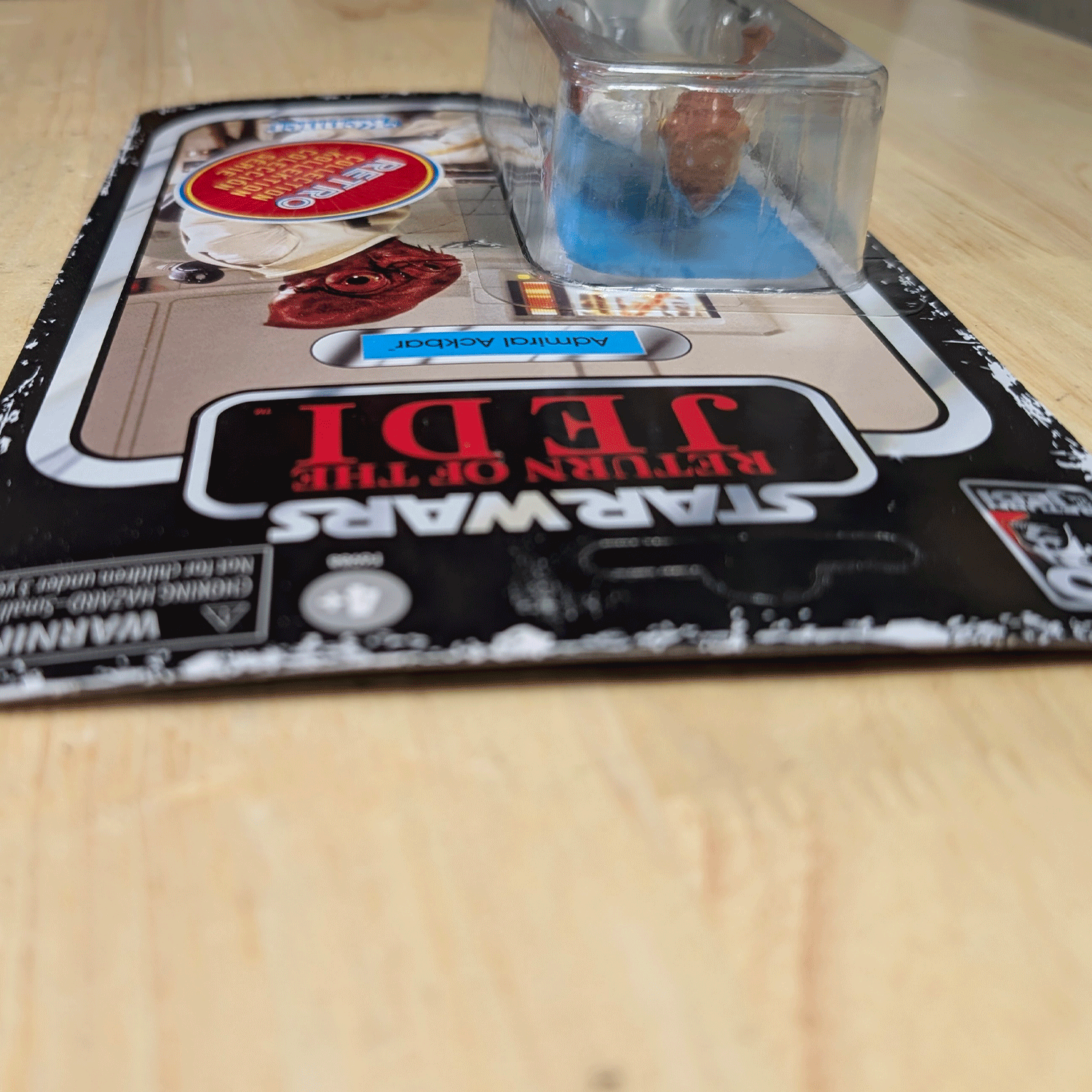 Vintage Kenner Star Wars Return of the Jedi Admiral Ackbar action figure unopened on wooden surface