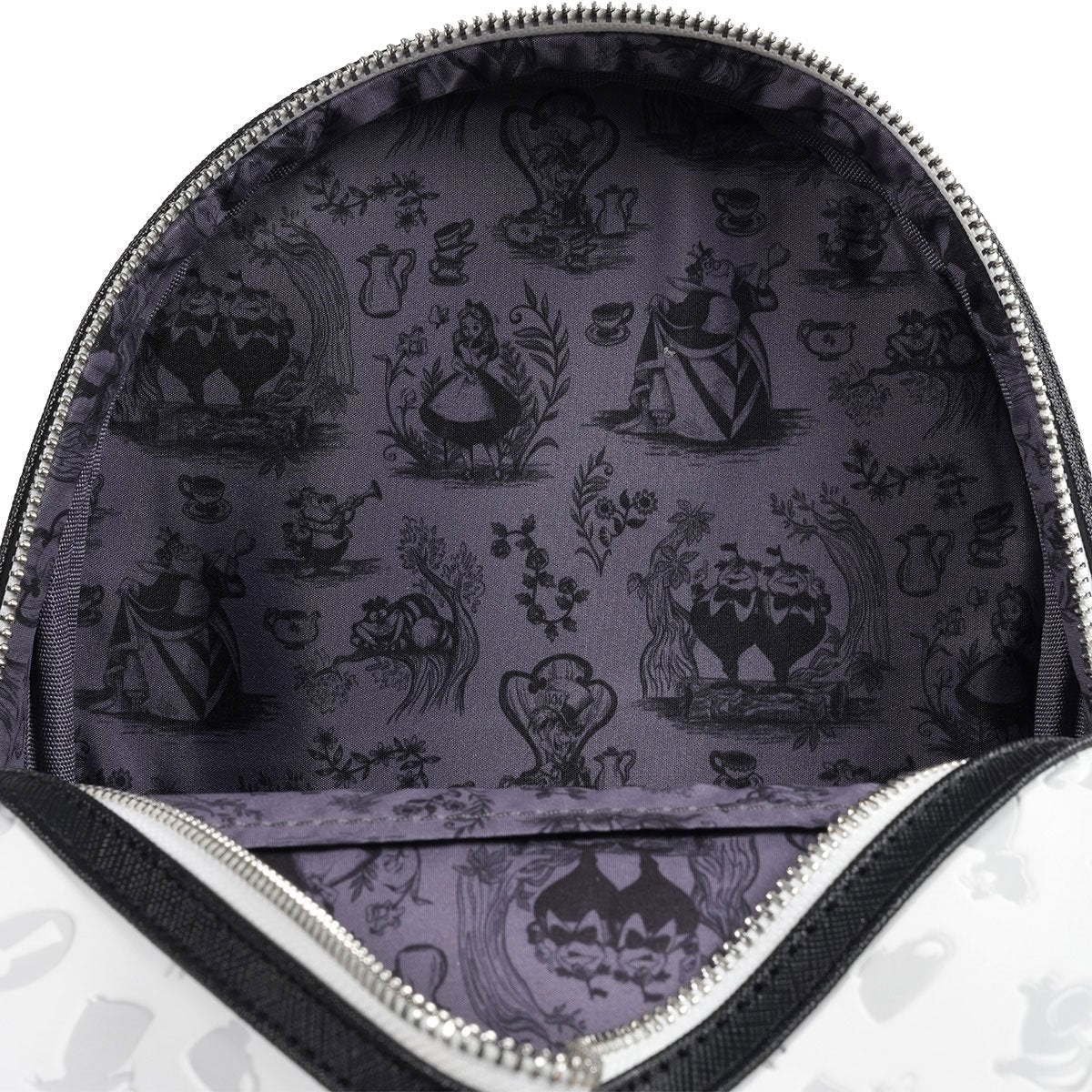 Close-up of a lavender fabric interior with black silhouettes of characters and teacups inside a zippered pouch or bag.