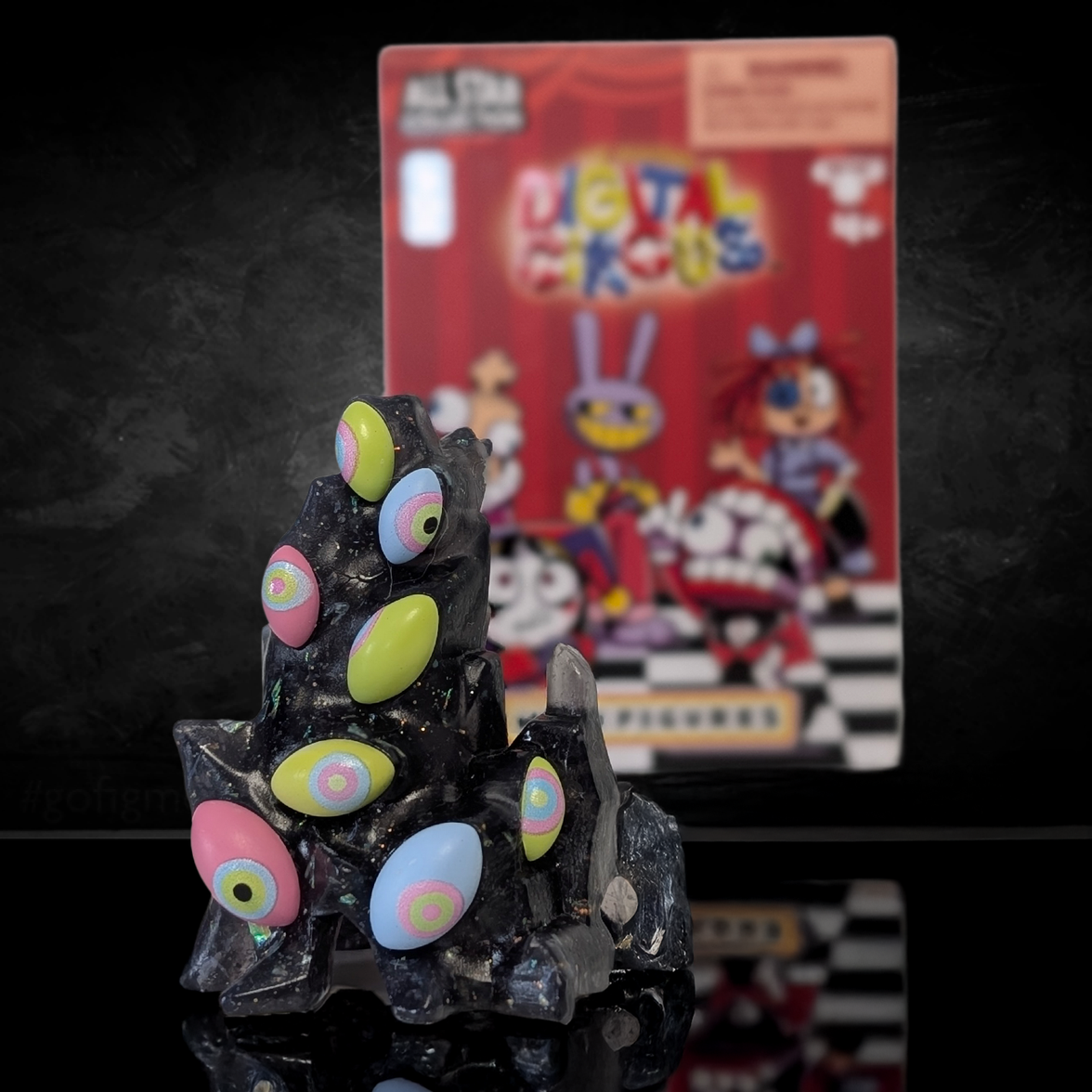 Digital Circus All Star Collection MiniFigures U-Pick collectible figure with colorful eyes by Glitch Studios in front of packaging.