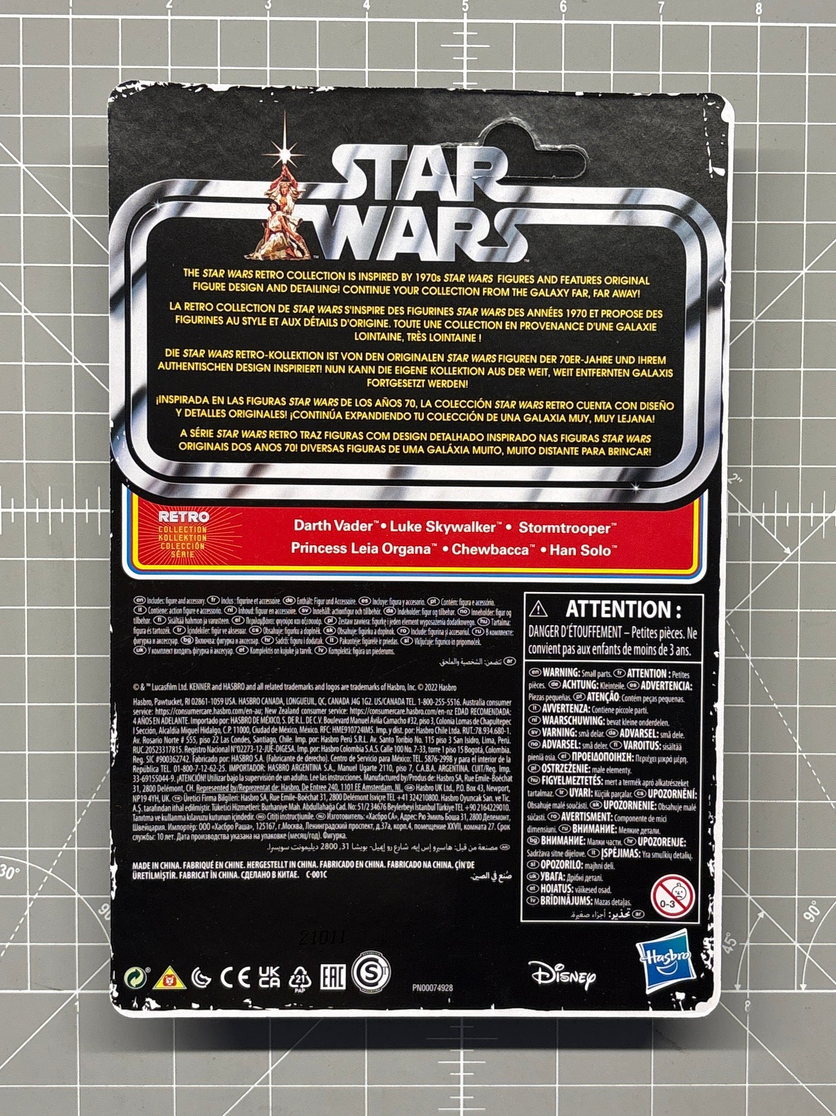 Back of Star Wars Retro Collection packaging with character names and Disney and Hasbro logos on a cutting mat