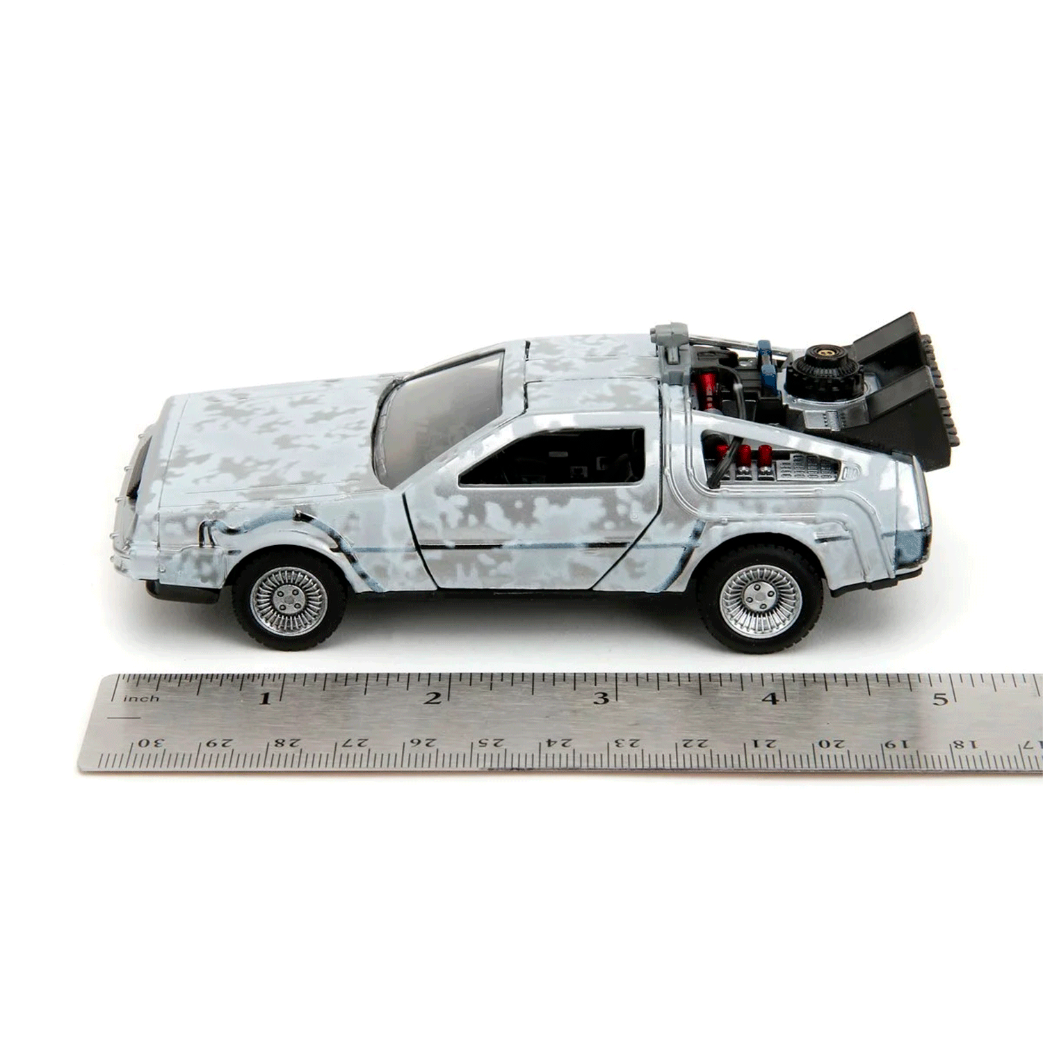 Go Figment Back to the Future Time Machine Frost 1:24 scale die-cast vehicle beside ruler for size comparison