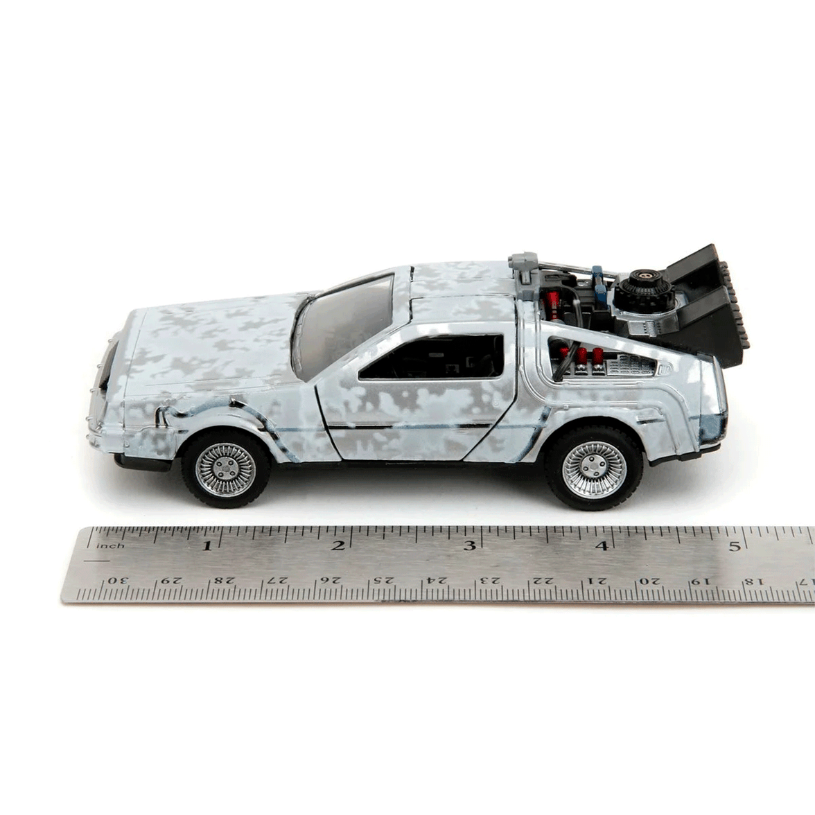 Go Figment Back to the Future Time Machine Frost 1:24 scale die-cast vehicle beside ruler for size comparison