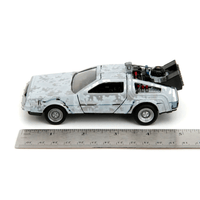 Go Figment Back to the Future Time Machine Frost 1:24 scale die-cast vehicle beside ruler for size comparison